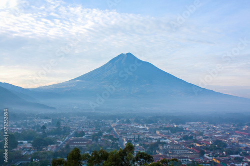 Agua volcano over Antigua valley with clouds and mist, Antigua Guatemala