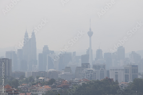 Картината върху платно Hazy Kuala Lumpur city skyscape due to  haze from forest fire