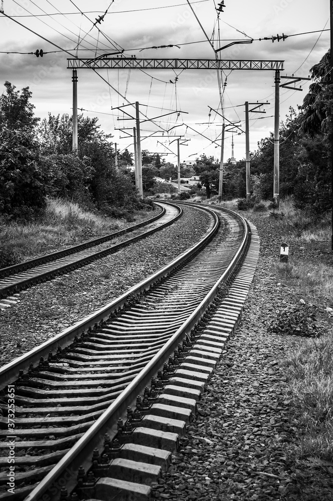 Parallel railway lines in black and white.