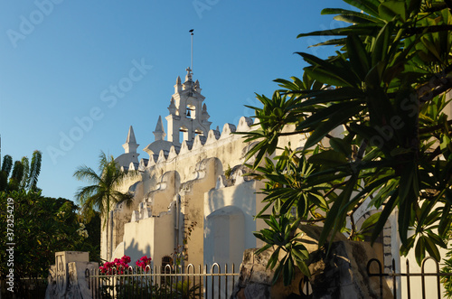 Apostle Church 'Parroquia de Santiago Apostol' with tropical plants, old Roman Catholic church with bell tower in Merida, Yucatan, Mexico