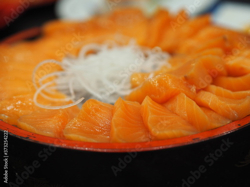 Fresh salmon fish arranged in a wooden tray style Japanese food