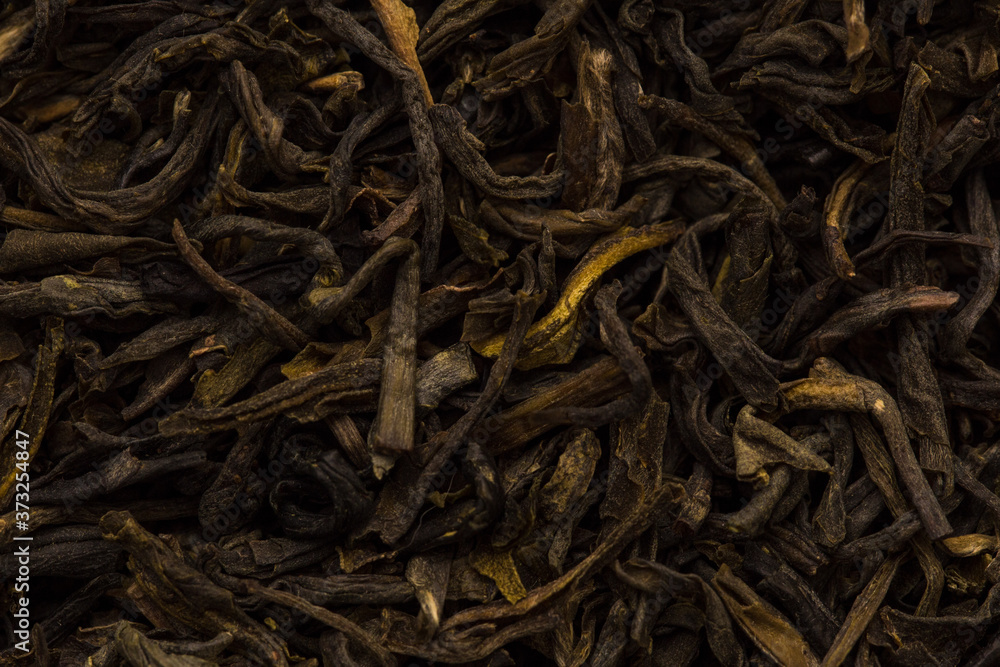 Filled abstract background of tea leaves. Black, green tea close up Filled abstract background of tea leaves. Black, green tea close up