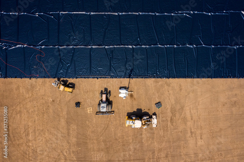 Fotografie Water reservoir construction site with newly installed plastic lining sheets, Aerial view