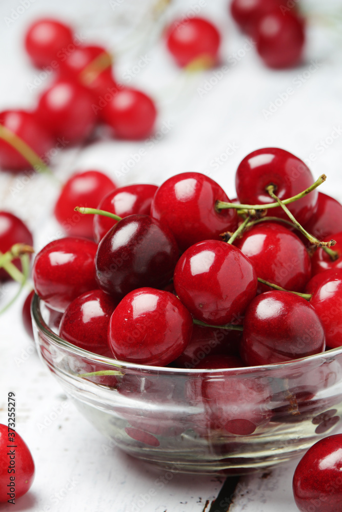 A small glass bowl with ripe fresh cherry A small glass bowl with ripe fresh cherry