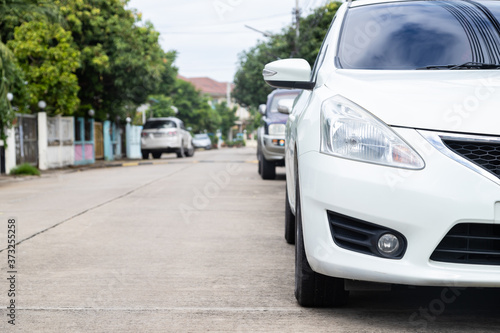 White car parked in a row on the road, outdoor parking © JC_STOCKER
