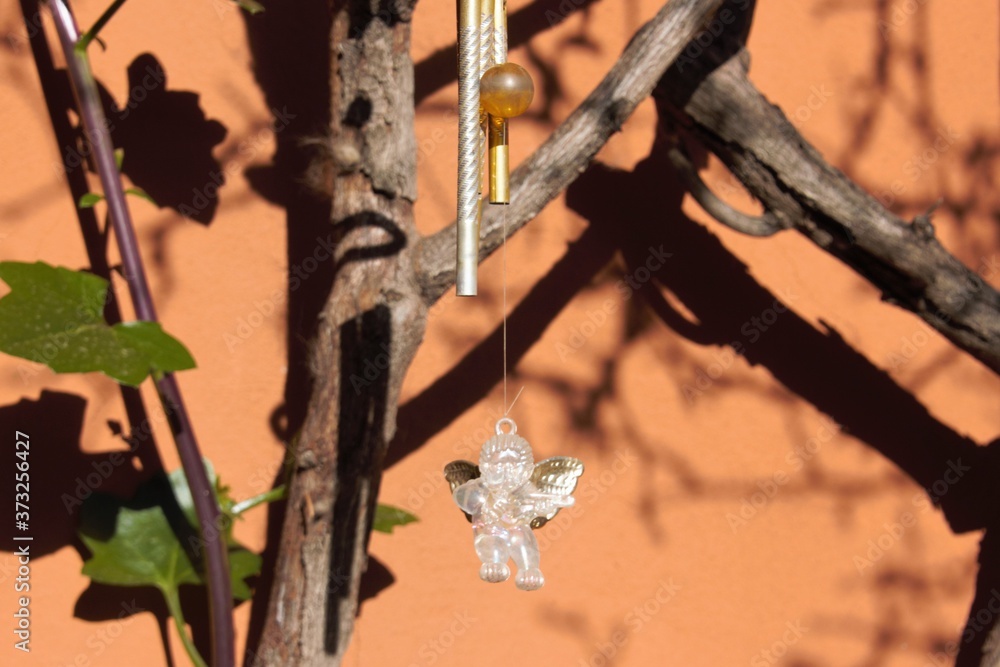a caller of angels hanging from the rose bush in my garden a caller of angels hanging from the rose bush in my garden