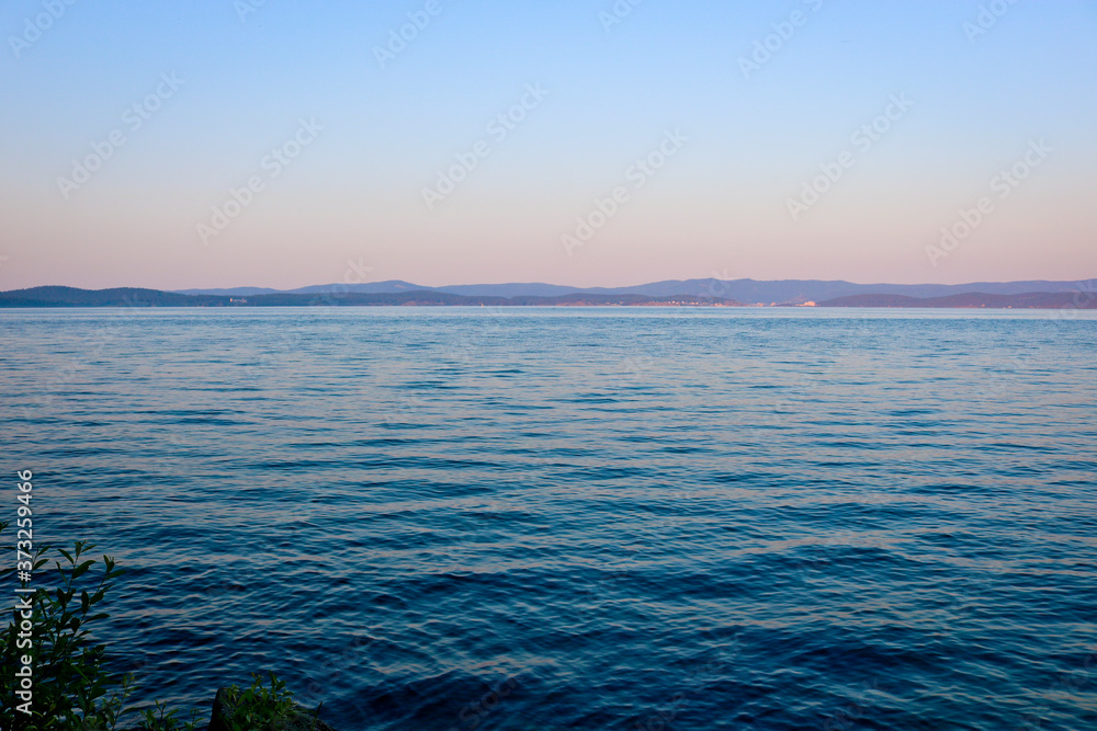 Obraz premium Lake in the evening light. Calm, clear water. The purest lake Turgoyak, Russia.