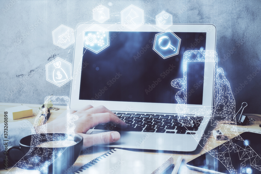 Technology theme hologram with man working on computer on background. High tech concept. Multi exposure.