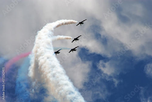 airshow planes group with smoke against the blue sky
