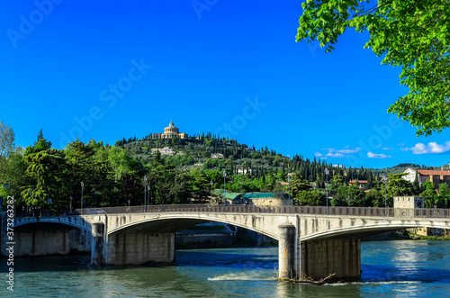 Verona Adige River Embankment view of the Garibaldi Bridge (Ponte Garibaldi) and the Sanctuary of the Madonna of Lourdes (Santuario della Madonna di Lourdes)