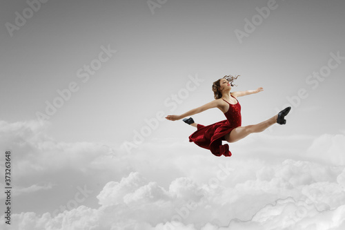 Female dancer against sky background