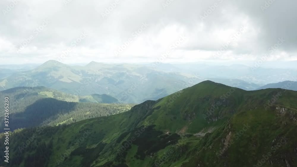 Drone flight over mountains and flag at the top Drone flight over mountains and flag at the top