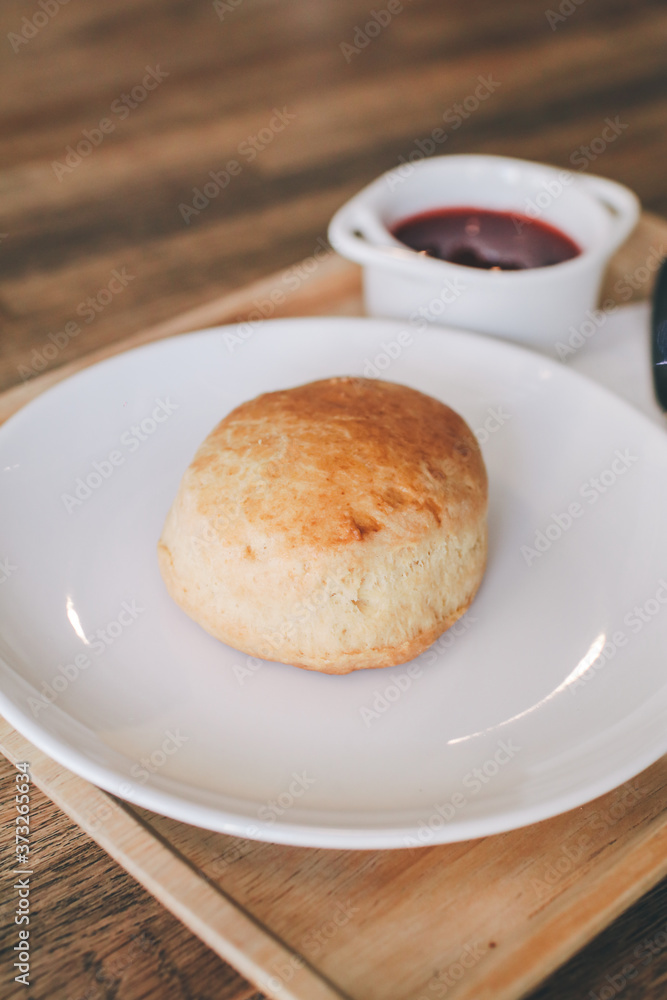 Close-up Homemade delicious English scone set with strawberry jam on the table. Horizontal,copy space for text, selective focus.