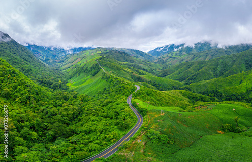 Aerial view of Beautiful sky road over top of mountains with green jungle in Nan province, Thailand.