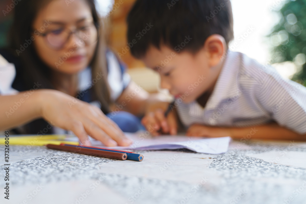Asian boy drawing and painting with his mother Asian boy drawing and painting with his mother