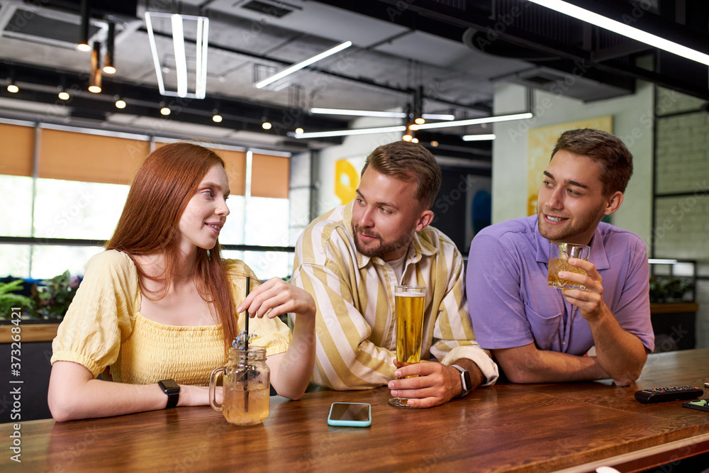 portrait of young caucasian people meeting for the first time in a bar, beautiful women and handsome guys talk and have fun, drink beverages portrait of young caucasian people meeting for the first time in a bar, beautiful women and handsome guys talk and have fun, drink beverages