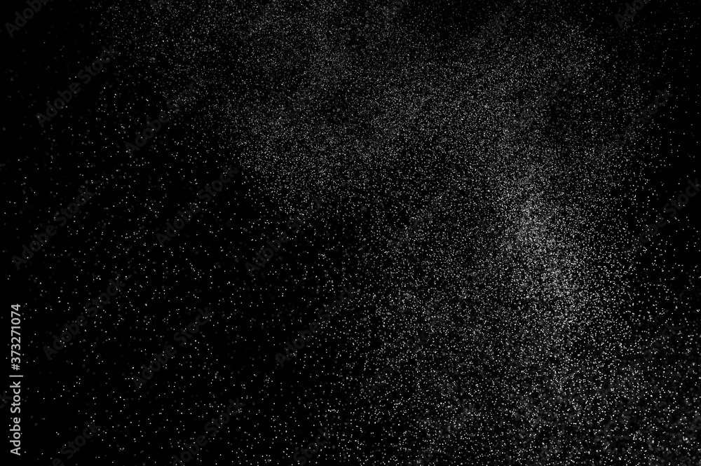 Abstract splashes of water on black background. Freeze motion of white particles. Rain, snow overlay texture. Abstract splashes of water on black background. Freeze motion of white particles. Rain, snow overlay texture.