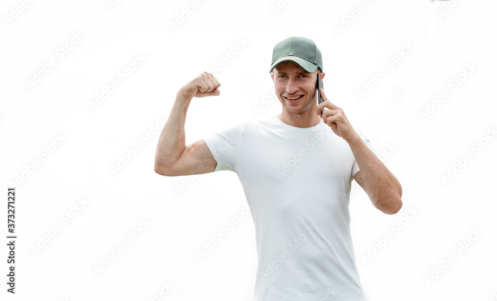 Portrait of cheerful handsome man smiling and looking at camera. Strong man. Phone. Happy day. Motivation. 