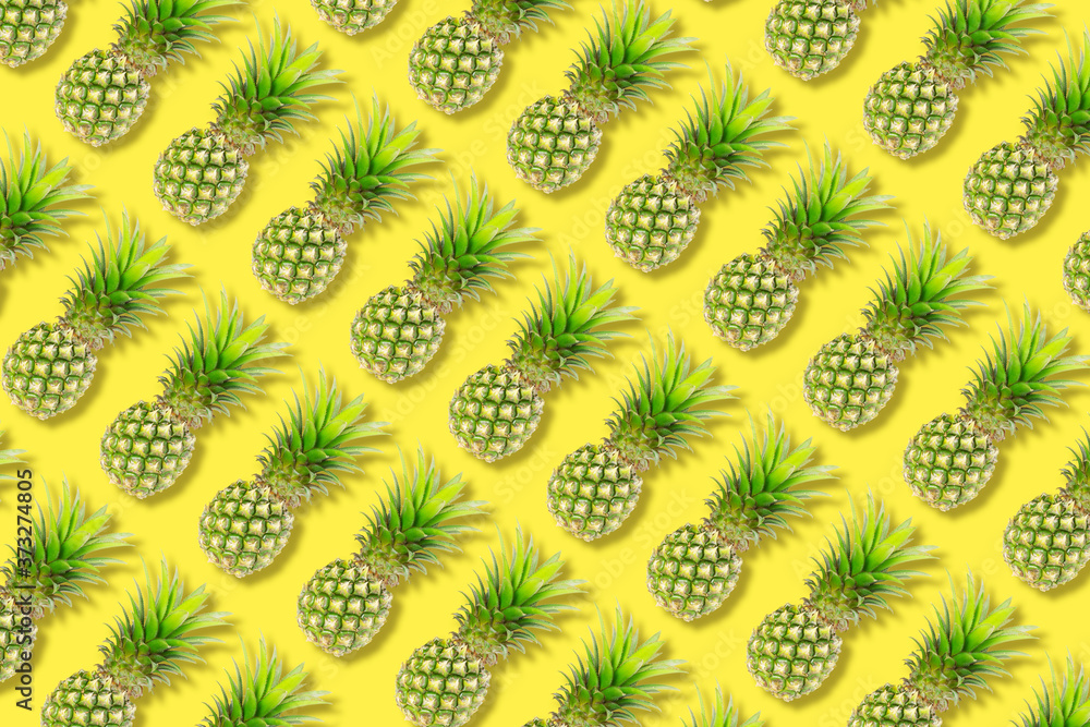 The texture colorful fruit pattern of pineapple fruit on yellow background, flat lay The texture colorful fruit pattern of pineapple fruit on yellow background, flat lay