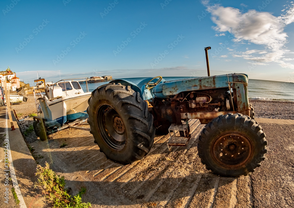 Fisheye view of a tractor, trailer and fishing boat on Cromer Beach on the North Norfolk Coast Fisheye view of a tractor, trailer and fishing boat on Cromer Beach on the North Norfolk Coast