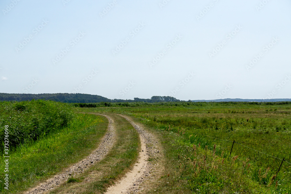 Unpaved curved road on a dike