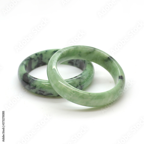 Carved and polished jade bangles. Green oriental gemstone bracelets.
