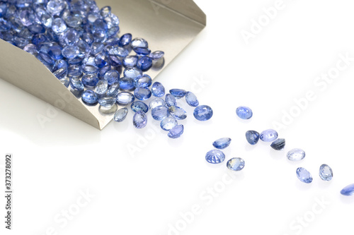 Precious blue sapphires on a jeweler's shovel. Precious polished stones.