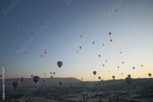 Hot air balloon flying over rock landscape at Cappadocia Turkey