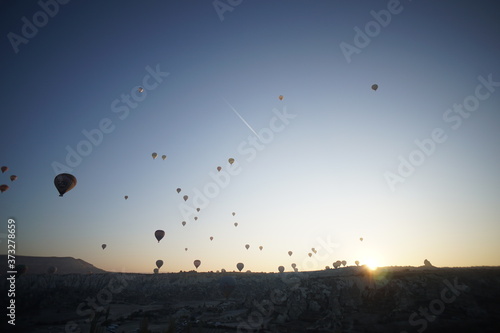 Hot air balloon flying over rock landscape at Cappadocia Turkey