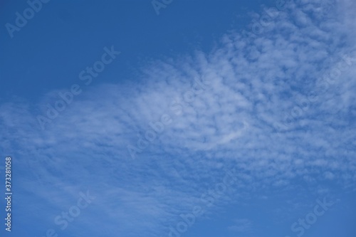 Photo of blue sky with tiny little white clouds