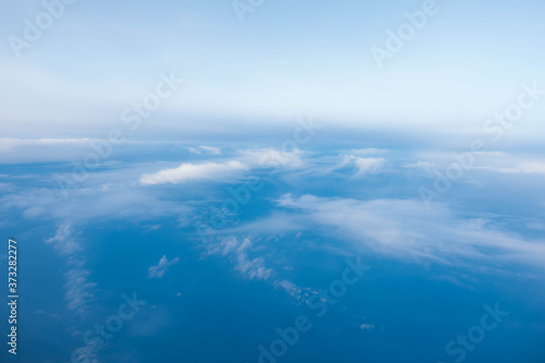 Cloud and blue sky from the airplane window © PinkBlue