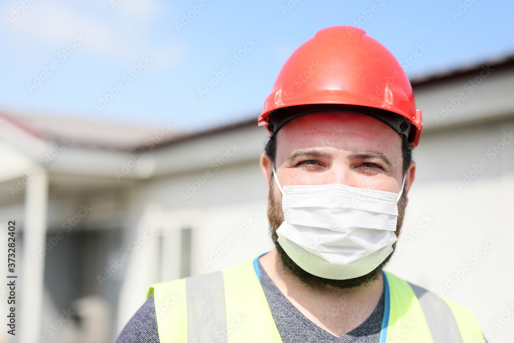 Occupational safety and health specialist is looking at the camera with protective mask for coronavirus (covid-19) in the construction site. Occupational safety and health specialist is looking at the camera with protective mask for coronavirus (covid-19) in the construction site.