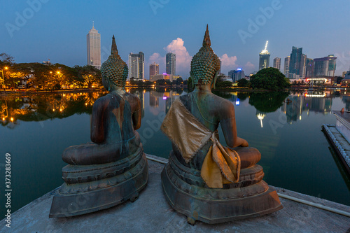 Skyline of Colombo through Buddha statues, Sri Lanka photo