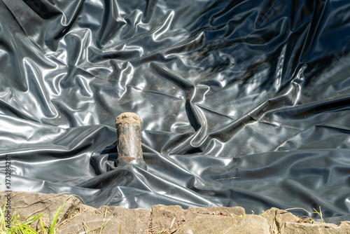 Wallpaper Mural Pond liner with visible sewer pipe Torontodigital.ca