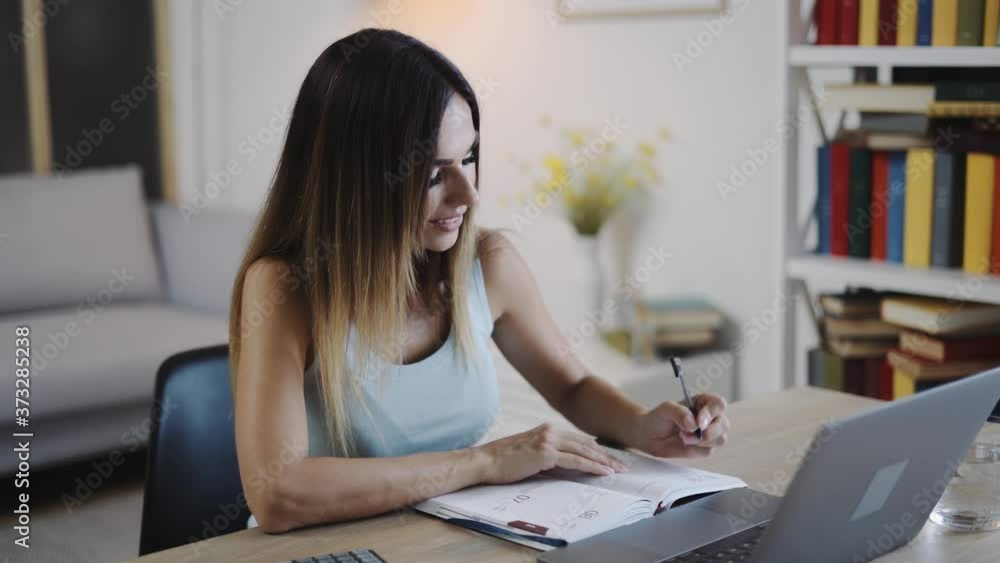 Beautiful Caucasian Woman Working From Home, Having Internet Lesson or Group Meeting, Using Video Conferencing Technology to Chat or Study. Beautiful Caucasian Woman Working From Home, Having Internet Lesson or Group Meeting, Using Video Conferencing Technology to Chat or Study.