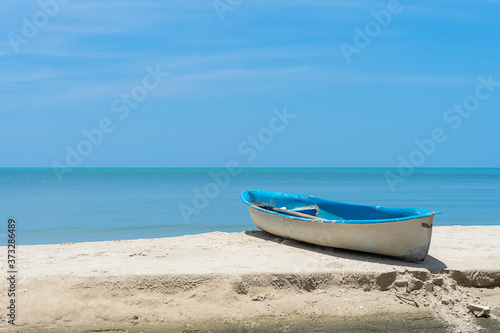 One boat on the beach with sky background.
