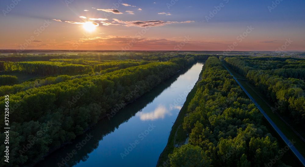 Nature river in forest at morning sunrise skyline