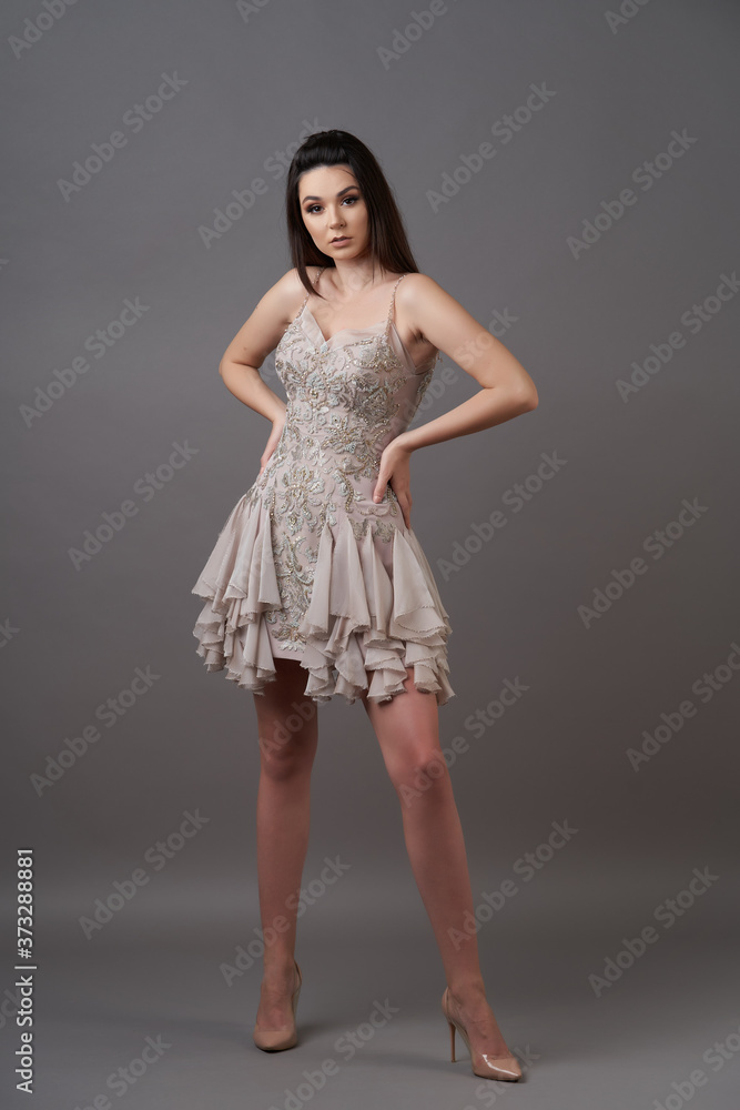 Portrait of a beautiful woman in trendy dress. Young brunette woman Portrait of a beautiful woman in trendy dress. Young brunette woman
