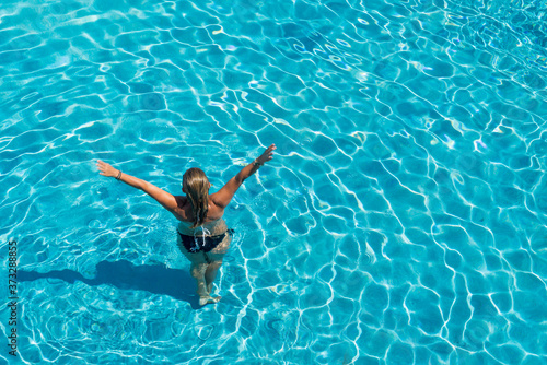 woman in luxury spa resort near the swimming pool.