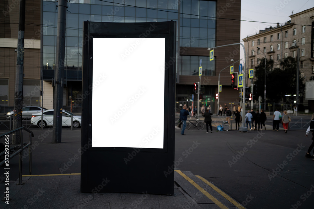 billboard in the city in the evening. Vertical billboard billboard in the city in the evening. Vertical billboard