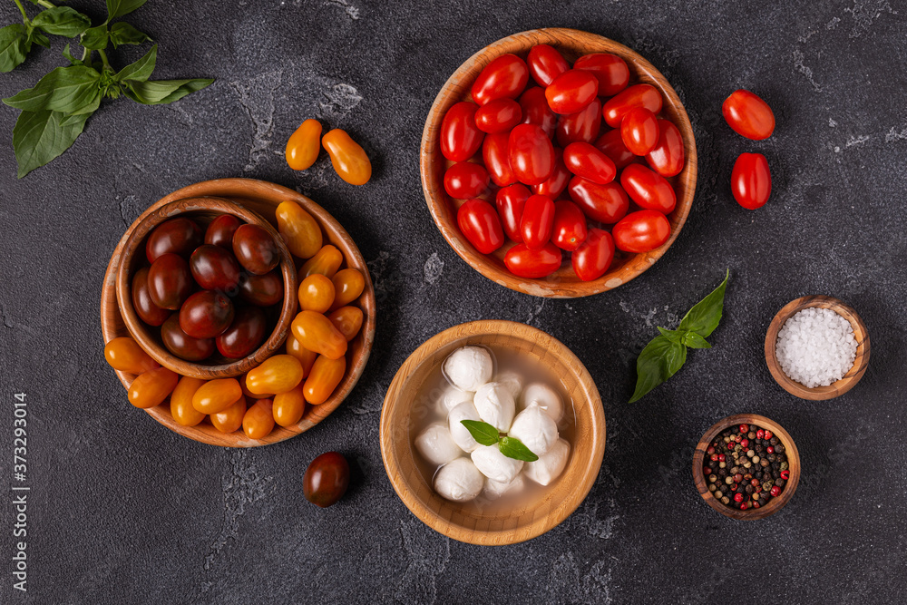 Ingredients for caprese salad: tomatoes, mozzarella and basil. Ingredients for caprese salad: tomatoes, mozzarella and basil.