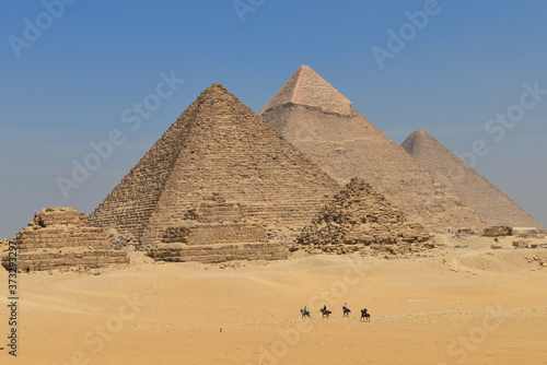 Five horse riders in Giza Pyramids in Cairo - Egypt