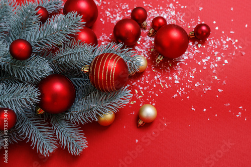 Christmas background in red and green. Nobody. Decorative composition: Christmas tree, large, small balls of red and gold, artificial snow. Top view. Horizontal, Place for text. Happy New Year theme.
