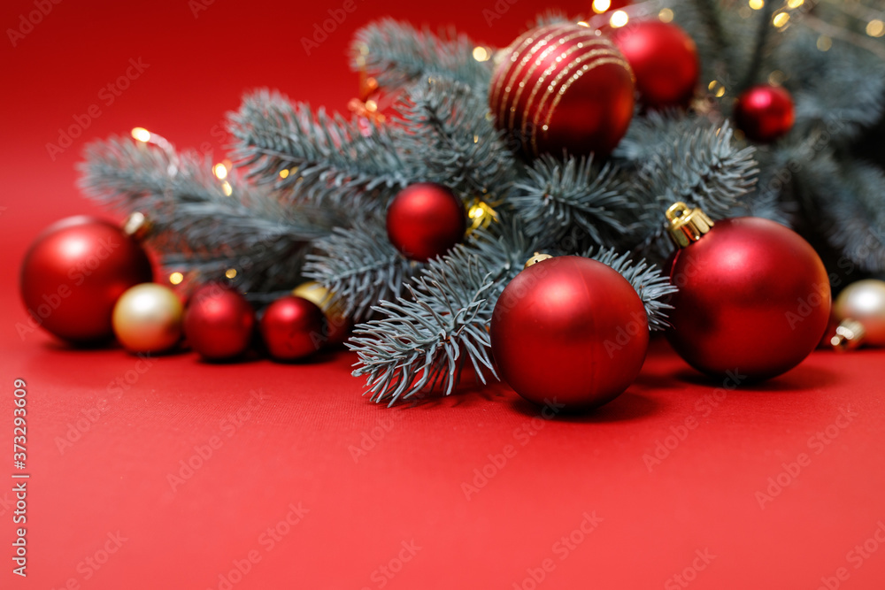 Winter holidays concept. Red, gold Christmas decorations on a red background with a Christmas tree, bokeh lights. Festive Christmas card. Happy New Year theme for layouts. Space for text. Horizontal