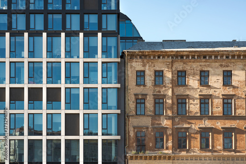 Front View of a Commercial Office and Apartment Building in the City Center, Typical Modern and Old Classic Architecture Side by Side