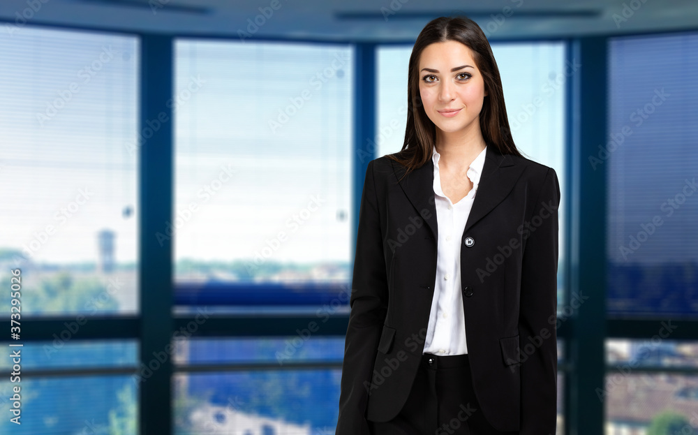 Smiling businesswoman portrait in a modern office Smiling businesswoman portrait in a modern office