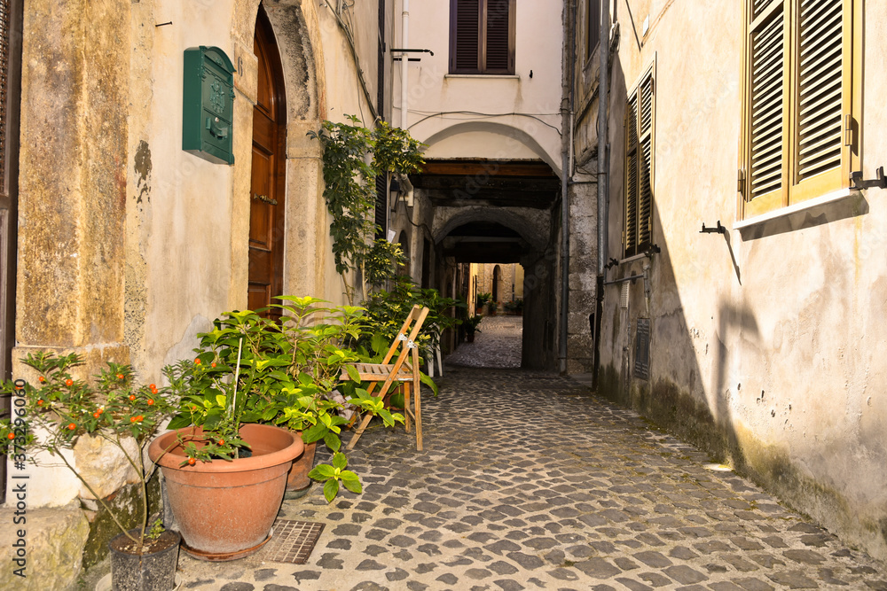 A narrow street among the old houses of Giuliano di Roma, a rural village in the Lazio region.