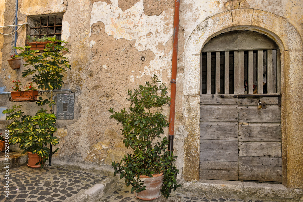 A narrow street among the old houses of Giuliano di Roma, a rural village in the Lazio region.