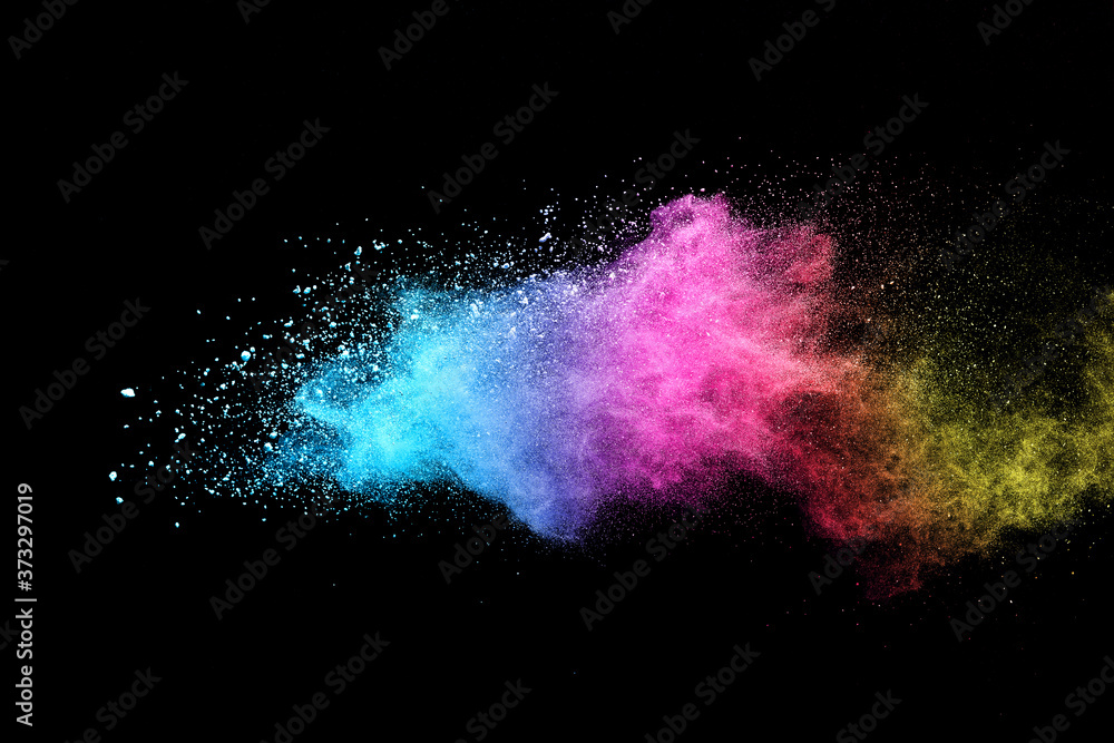 Fototapeta Explosion of colored powder isolated on black background.