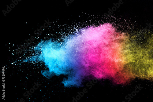 Explosion of colored powder isolated on black background. 